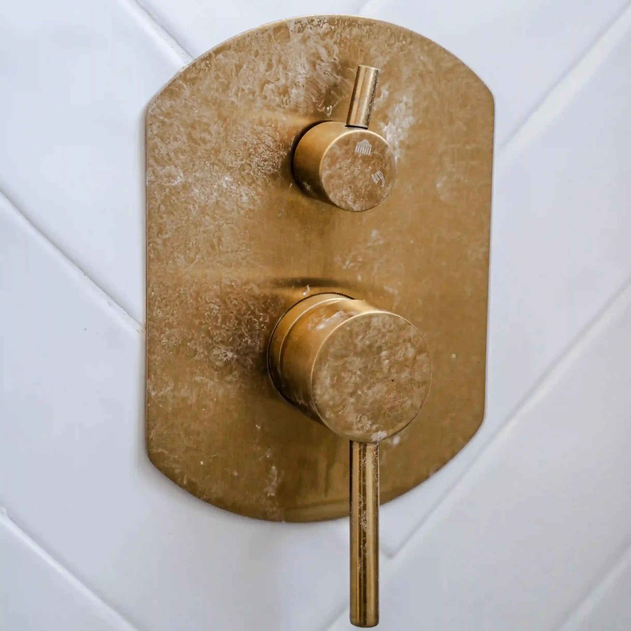 Brass tap with heavy white limescale build-up, before Nordic Freezz hard water protection