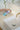 Applying Nordic Freezz spray on a bathroom sink – protects surfaces from water marks, soap scum, and dirt. self-cleaning and surface protection hygiene bathroom care household cleaning product